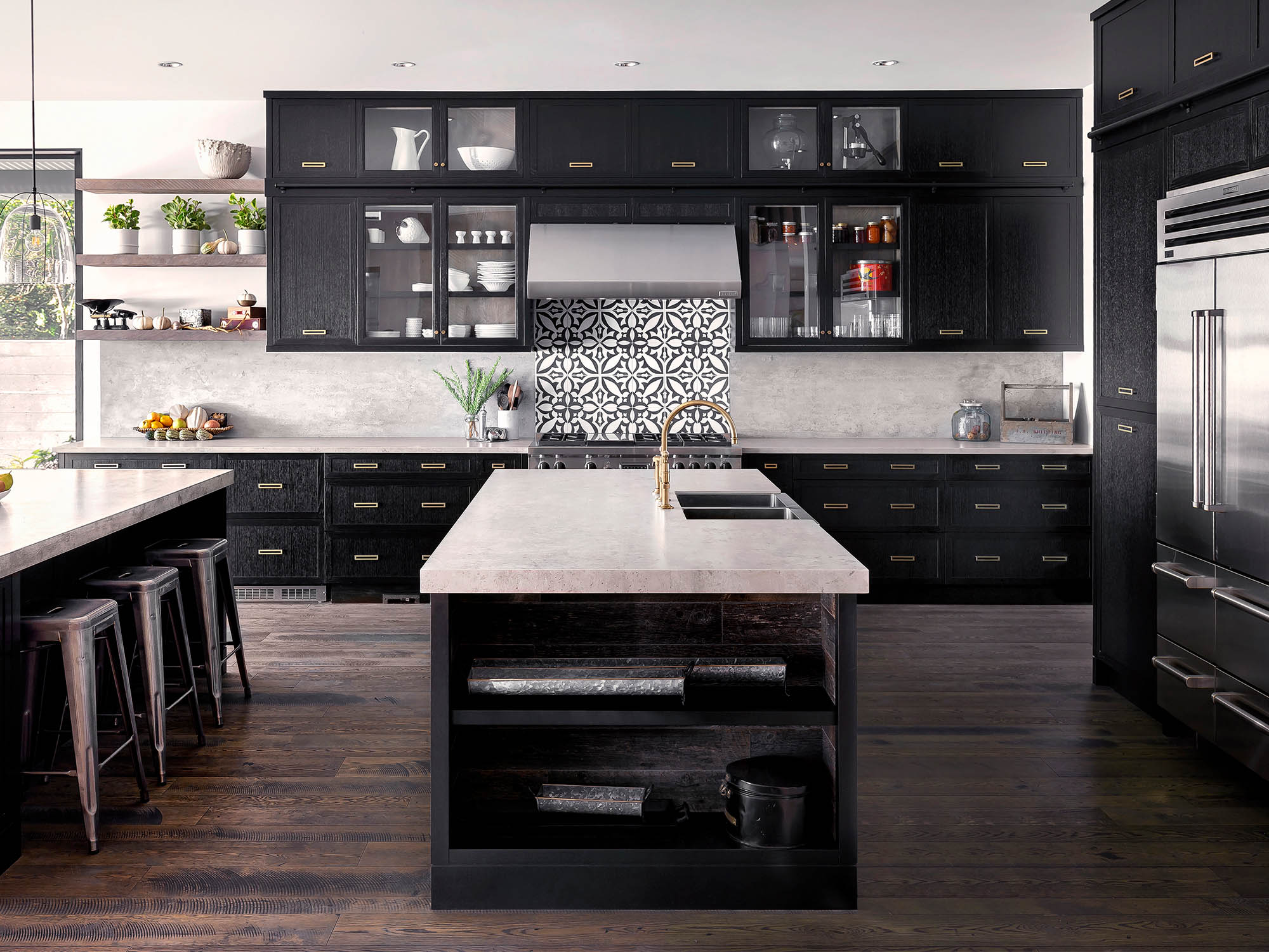Modern dark wood kitchen with white granite countertops and Moroccan tile backsplash.