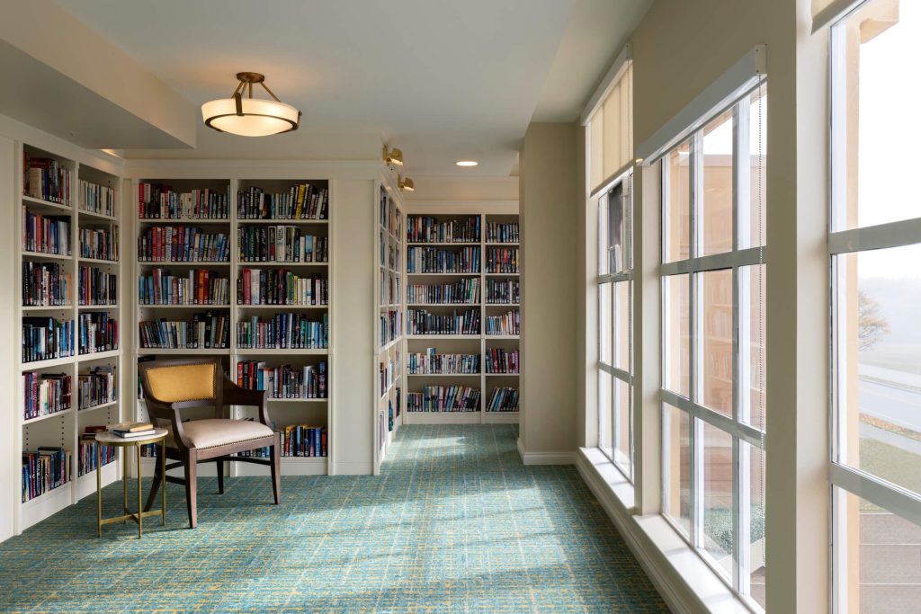 Bright modern library reading area with floor to ceiling windows interior design architectural photography Tony Colangelo.