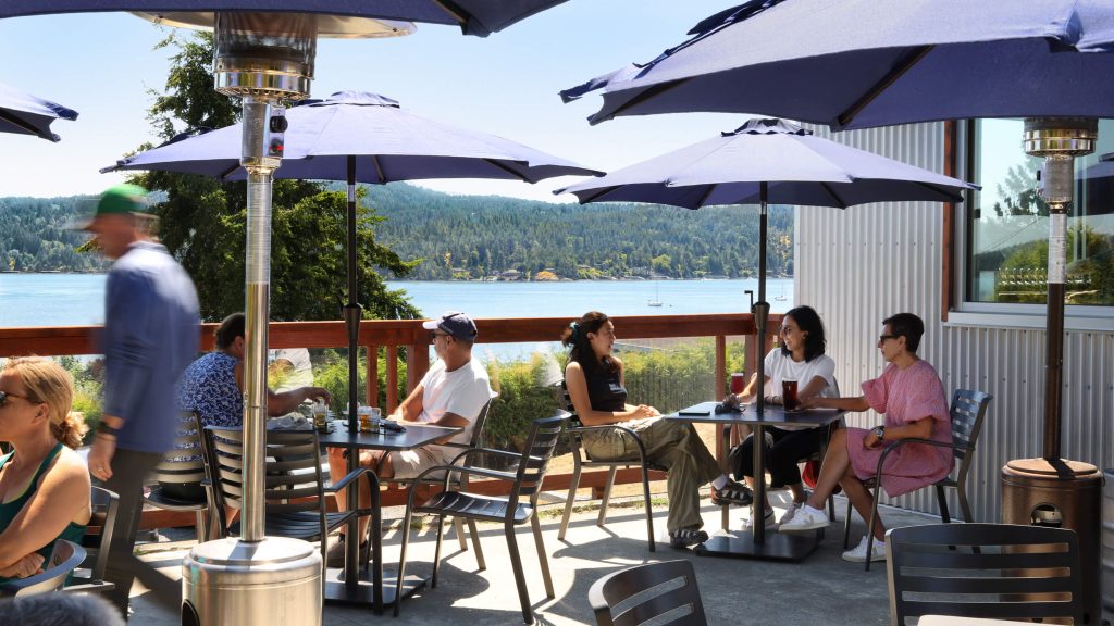 Patrons sit on on a sunlit patio, exterior design photography in Vancouver, Victoria, Cowichan Valley and Nanaimo.