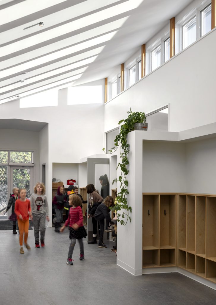 Children enter bright modern foyer with skylights, interior design photography in Nanaimo, Victoria and Vancouver.