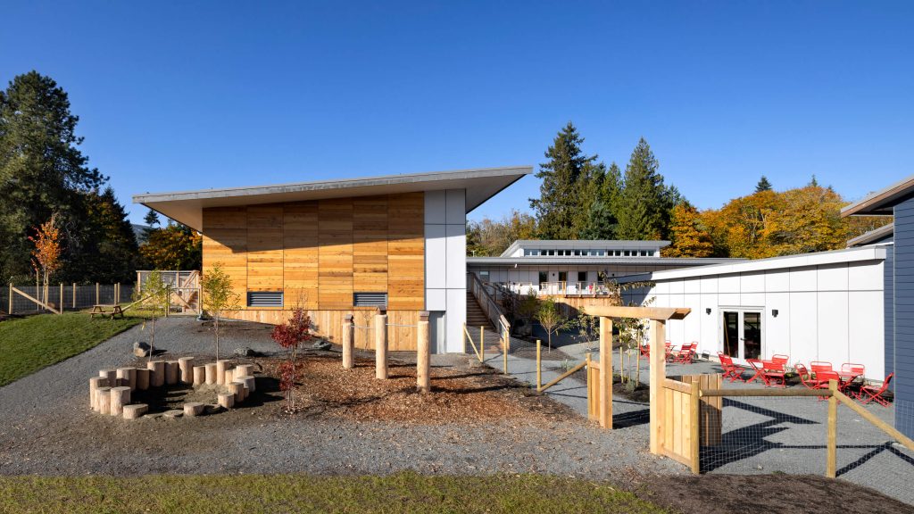 Natural playground with wood paneled building, architectural exterior design photography in Nanaimo, Cowichan Valley, Victoria and Vancouver.